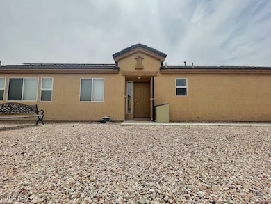 Rear view of property with stucco siding