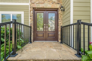 Property entrance with french doors and stone siding