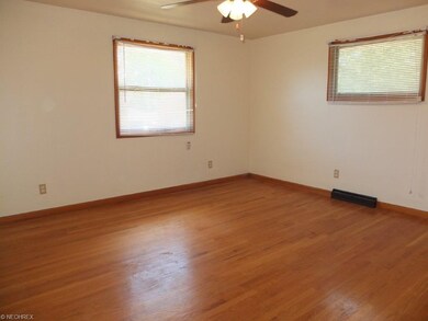 Bedroom 1 with hardwood flooring.