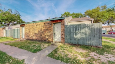 View of outbuilding with fence