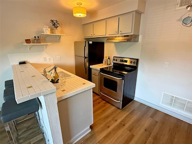 Kitchen featuring appliances with stainless steel