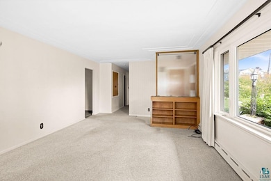 Empty room with baseboard heating and light colore