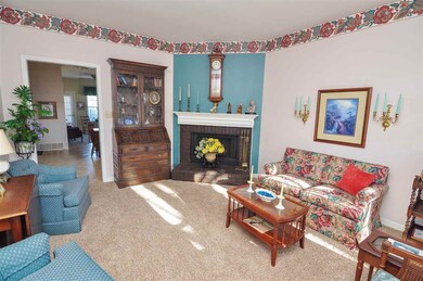 A cozy fireplace highlights the living room to enj