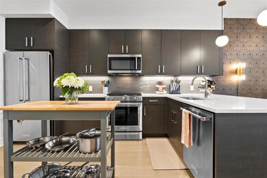 Kitchen featuring backsplash, a sink, light wood-
