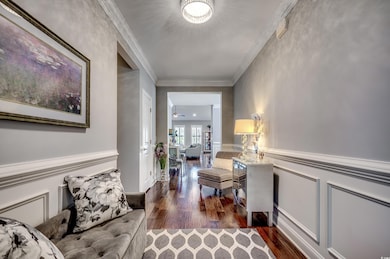 Corridor with crown molding and dark hardwood / wood-style flooring