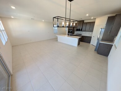Kitchen with open floor plan, backsplash, hanging light fixtures, light tile patterned floors, and recessed lighting