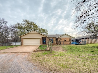 Ranch-style house with brick siding, concrete driv