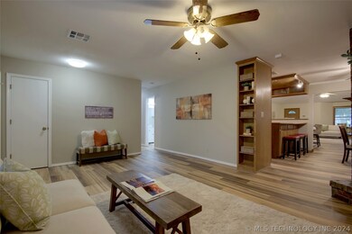 The hall to the left leads to the secondary bedrooms and the opening to the right leads to the breakfast nook/kitchen.
