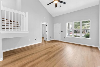 Unfurnished living room featuring high vaulted cei