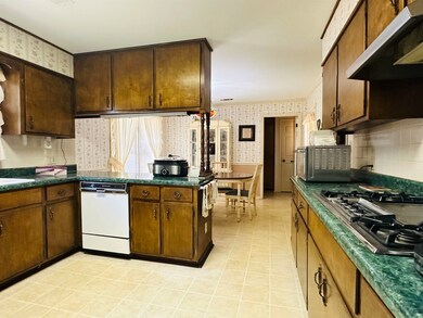 Kitchen with dark brown cabinets, stainless steel 