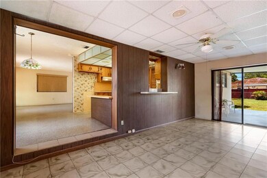 Large family room with access to covered patio in