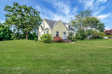 New england style home with a front lawn