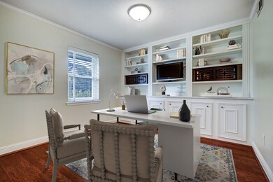 Virtually staged. Home office with wall of bookshe