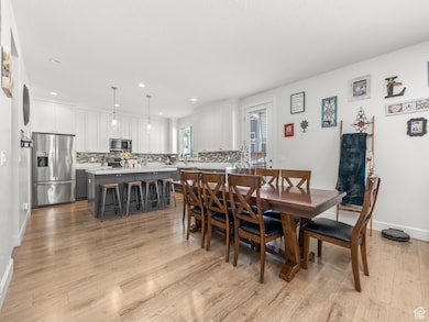 Dining room with light flooring / wood-style floors and sink