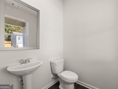 Sample Flora Half Bathroom at Oaks at Cedar Grove in Fairburn, Georgia