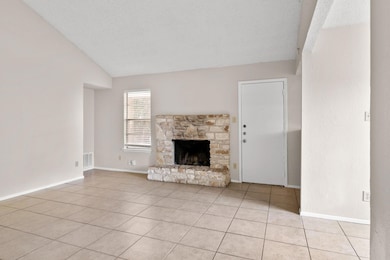 Unfurnished living room featuring light tile patt