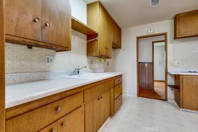 Kitchen with wood cabinets, Formica counters