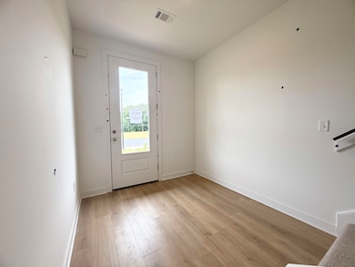Entrance foyer featuring light wood-type flooring and baseboards