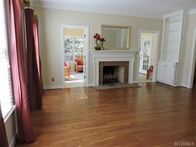 Living room with wood burning fireplace, built-ins