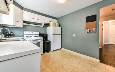 Kitchen offers white kitchen cabinets, gas stove a