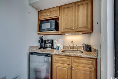 Kitchen featuring black microwave, a sink, dishwas