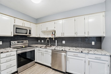 Updated Kitchen '22 with Hardware, Wood Look Ceramic Plank Flooring, Stainless Steel Appliances, Granite Counters, and Tile  Black-splash, Freshly Painted '25