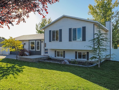Tri-level home featuring a wooden deck and a chimney