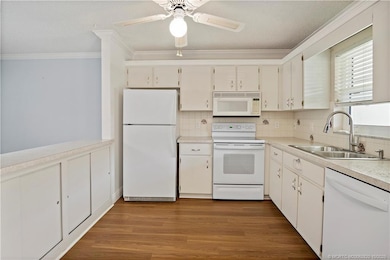 Nice, Clean, Spacious Kitchen - Cabinets on BOTH sides of the Breakfast Bar - Newer Floors continue through the Kitchen