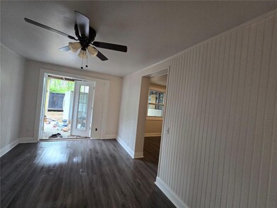 Unfurnished room with dark hardwood / wood-style floors and ceiling fan
