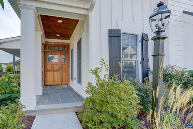 Covered front porch with stained beadboard ceiling