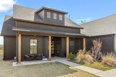 View of front of home with brick siding, board and