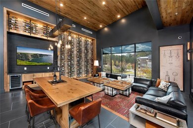Wine cellar featuring wine cooler, a towering ceil