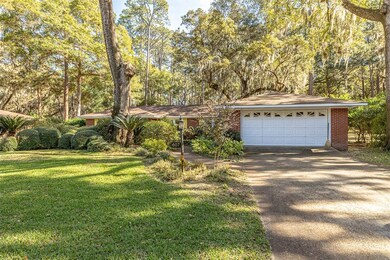 Front with paved driveway and two-car garage