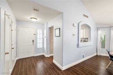 Entrance foyer featuring baseboards, vaulted ceili