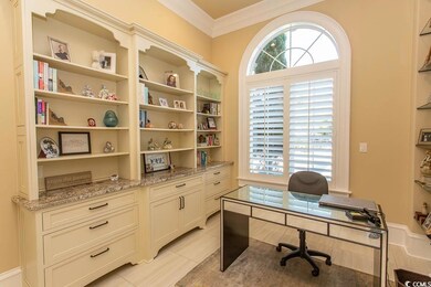 Office area featuring light tile patterned flooring and ornamental molding