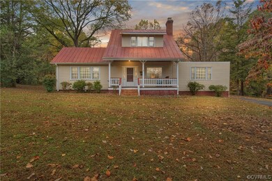 View of front facade with a porch and a lawn