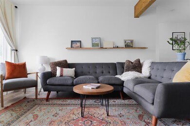 Living area featuring wood finished floors and be