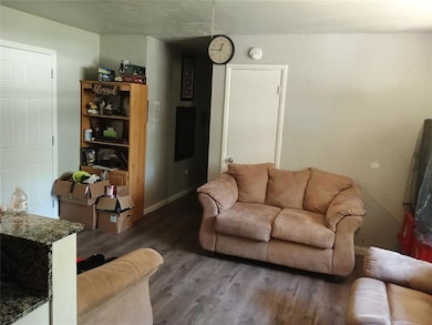 Living area with wood finished floors and baseboards
