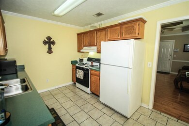 Kitchen features a gas range.