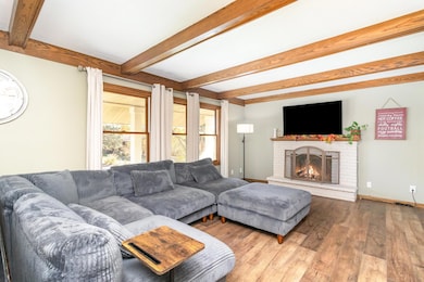 Bright and cozy living room on the main level with wood burning fireplace