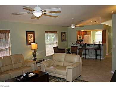 View of living room to breakfast bar area into kit