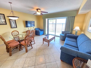 Living room with light tile patterned flooring, a 