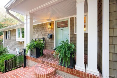 Welcoming front porch with pair of staircases to l