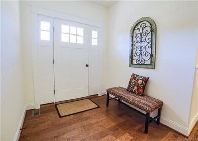 Inviting Foyer Showcases Beautiful Hard Wood Floor