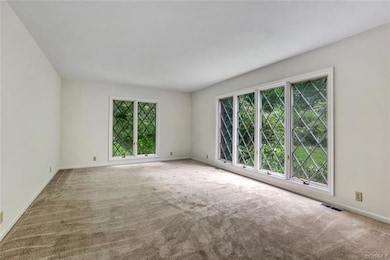 Sunny formal living room with large casement windo