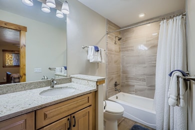 Full bath featuring shower / tub combo and vanity