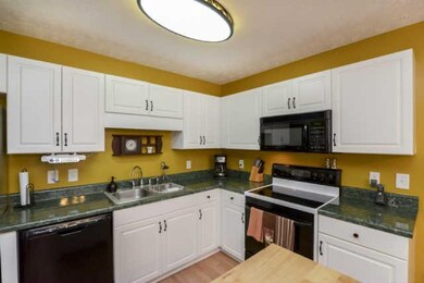 The 18 by 12 Eat-in Kitchen has updated lighting a