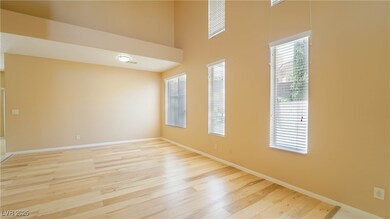 Empty room with light wood-style floors and a towe