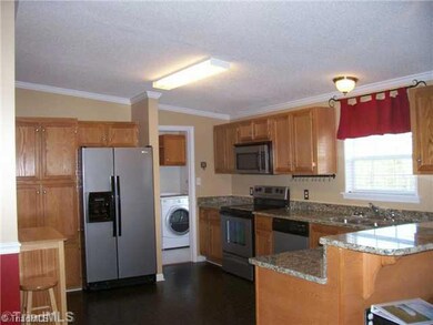 Kitchen. Oak cabinetry, granite tops, whirlpool stainless steel appliances. Kitchen is open to Living Room and Dining Room. Laundry is off the kitchen. Kitchen size is 11 6
