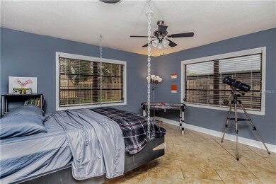 The third bedroom is tiled and has windows on two 